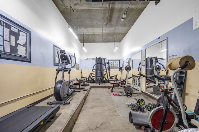 exercise room with a towering ceiling