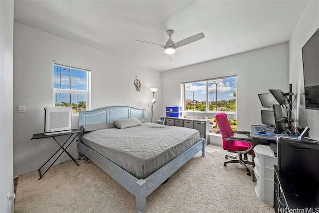 bedroom with ceiling fan, cooling unit, and light colored carpet