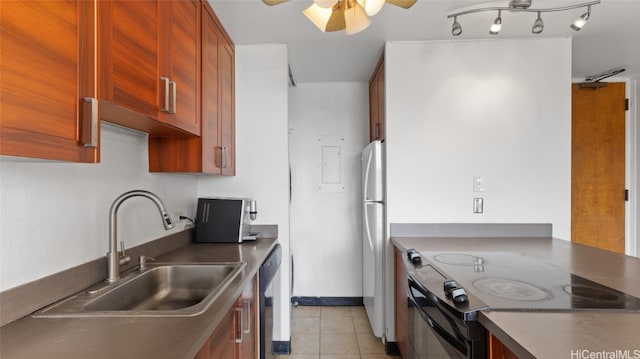 kitchen with light tile patterned flooring, stainless steel appliances, sink, and ceiling fan