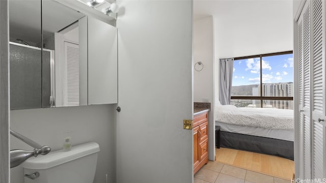 bathroom with a shower with door, toilet, hardwood / wood-style flooring, and vanity