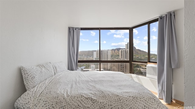 bedroom featuring wood-type flooring and floor to ceiling windows