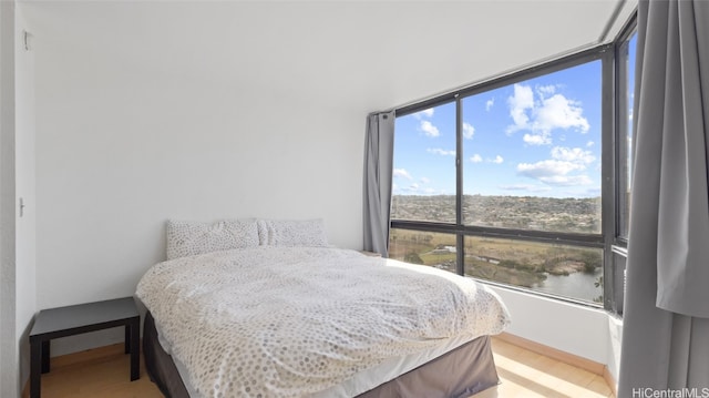 bedroom featuring wood-type flooring and multiple windows