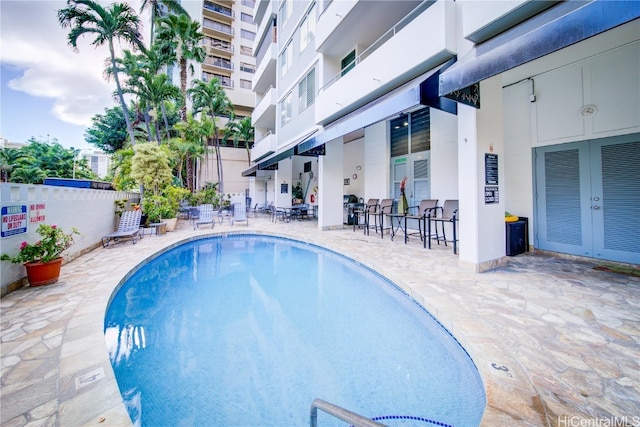 view of swimming pool with a patio area