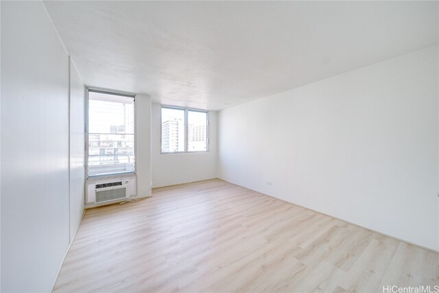 unfurnished room featuring light hardwood / wood-style flooring and cooling unit