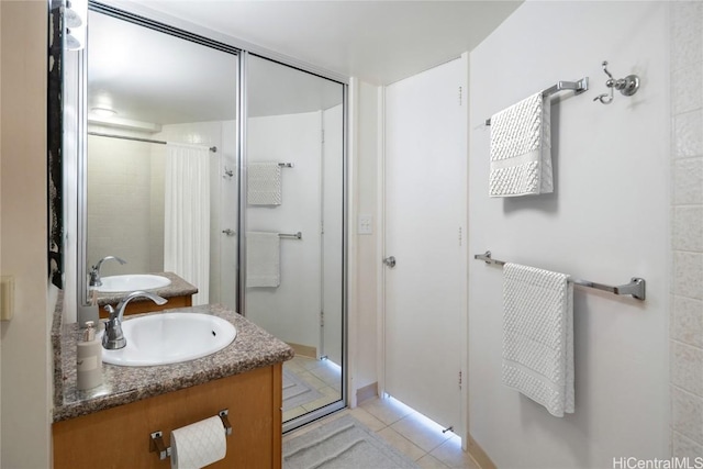 bathroom featuring vanity, tile patterned floors, and walk in shower