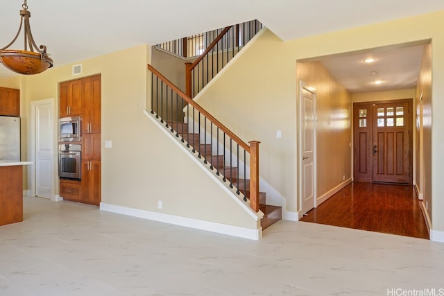 foyer entrance with light hardwood / wood-style flooring