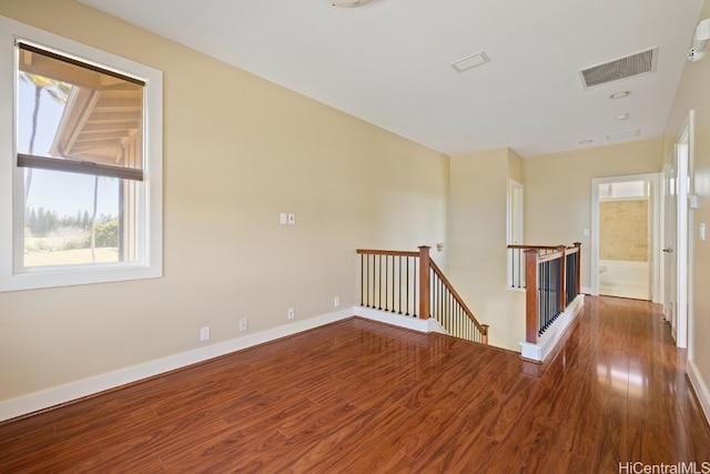 spare room with wood-type flooring