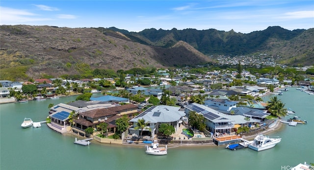 drone / aerial view featuring a water and mountain view