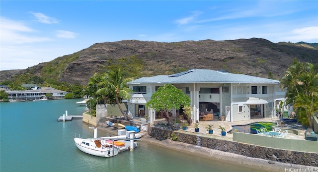 water view with a mountain view and a boat dock