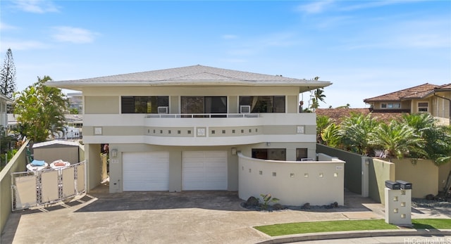 view of front of home featuring a balcony and a garage