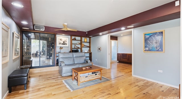 living room featuring light hardwood / wood-style floors and ceiling fan