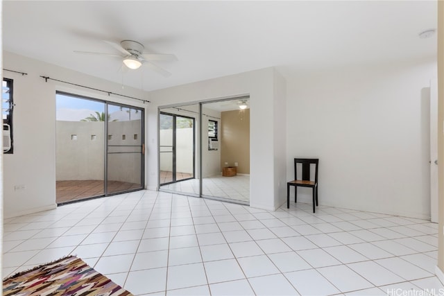 unfurnished bedroom featuring ceiling fan, light tile patterned floors, and a closet