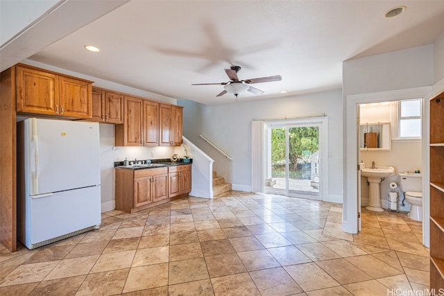 kitchen with ceiling fan, sink, light tile patterned floors, and white refrigerator