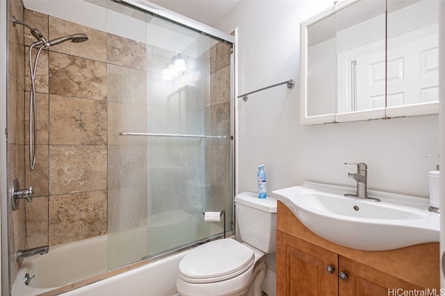 full bathroom featuring vanity, enclosed tub / shower combo, and toilet