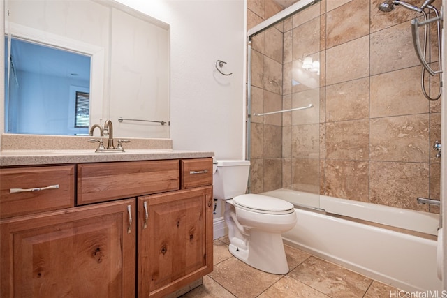 full bathroom featuring toilet, bath / shower combo with glass door, vanity, and tile patterned flooring