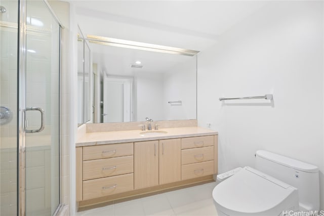 bathroom with vanity, a shower with shower door, and toilet