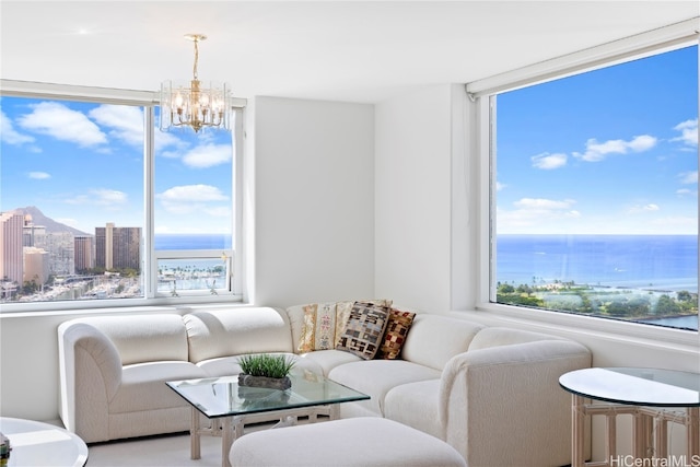 living room with a chandelier, a water view, and a wealth of natural light