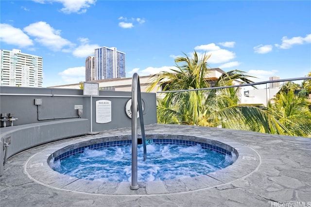 view of pool with a hot tub