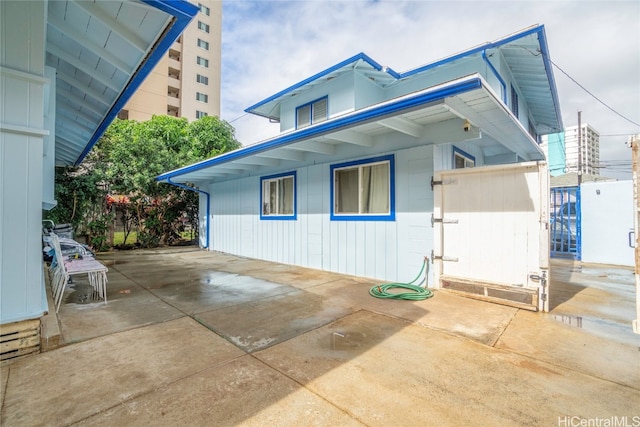 view of property exterior with a patio area