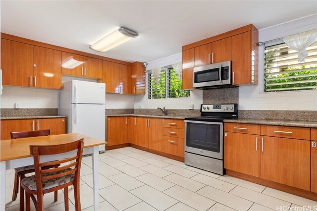 kitchen featuring stainless steel appliances and tasteful backsplash