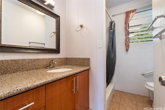 bathroom with vanity, tile patterned flooring, toilet, and walk in shower