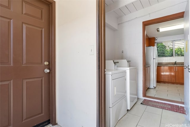 laundry room featuring light tile patterned flooring and separate washer and dryer