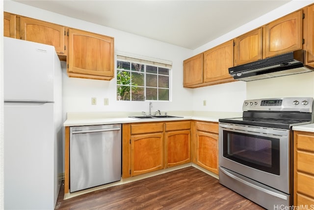 kitchen with dark wood-type flooring, stainless steel appliances, extractor fan, and sink