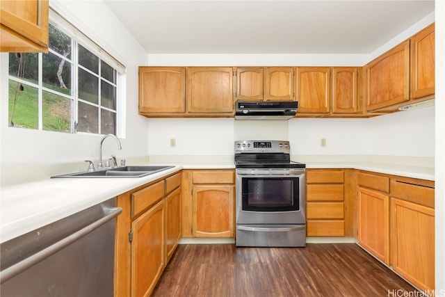 kitchen featuring sink, appliances with stainless steel finishes, dark hardwood / wood-style floors, and extractor fan