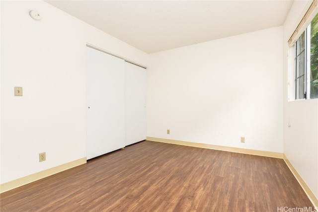 spare room featuring dark wood-type flooring