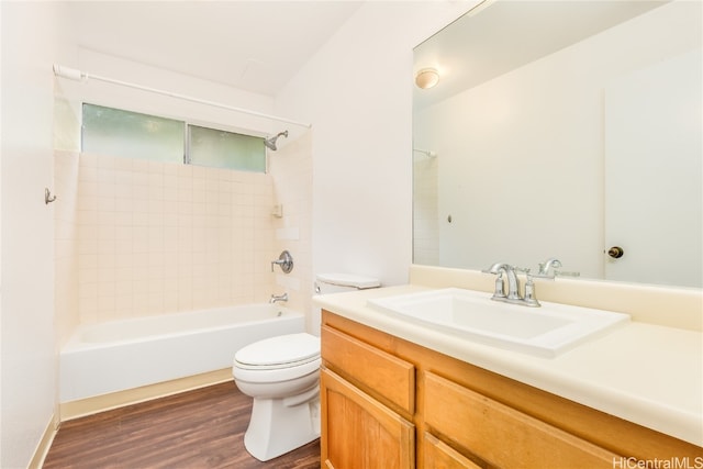 full bathroom featuring vanity, toilet, tiled shower / bath, and hardwood / wood-style floors