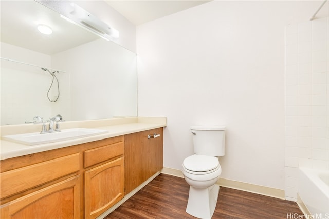 full bathroom with toilet, vanity, wood-type flooring, and tub / shower combination