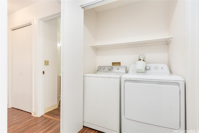 laundry room featuring hardwood / wood-style floors and independent washer and dryer