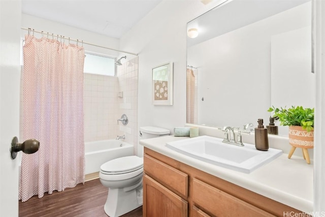 full bath with vanity, wood finished floors, toilet, and shower / tub combo with curtain