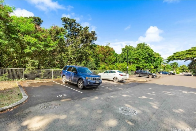 uncovered parking lot with fence