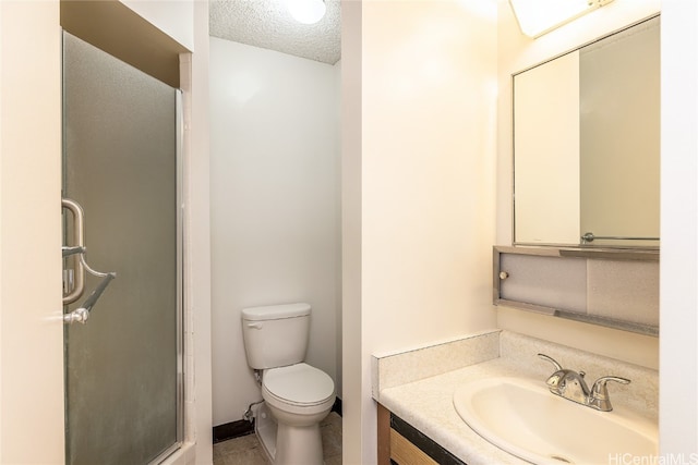 bathroom with toilet, a textured ceiling, vanity, and a shower with door