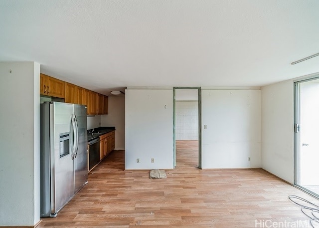 kitchen featuring sink, stainless steel fridge with ice dispenser, light wood-type flooring, and dishwasher