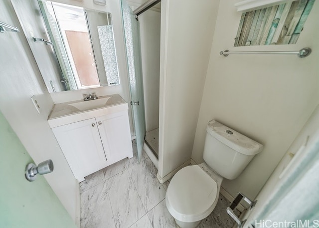 bathroom with vanity, walk in shower, and toilet