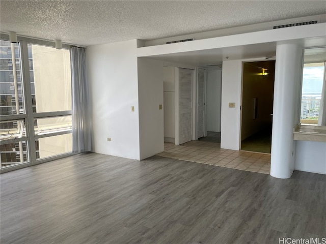 unfurnished room featuring a textured ceiling and wood-type flooring