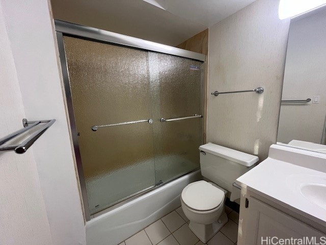 full bathroom with vanity, toilet, shower / bath combination with glass door, and tile patterned flooring