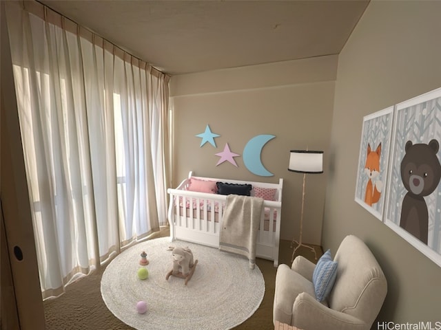 carpeted bedroom with a crib