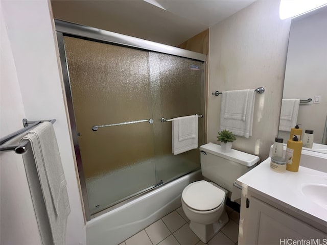 full bathroom with vanity, enclosed tub / shower combo, toilet, and tile patterned floors