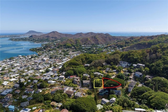 birds eye view of property with a water and mountain view