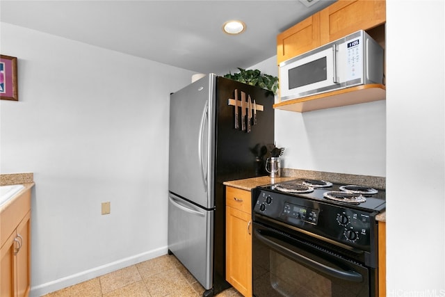 kitchen featuring black electric range oven and stainless steel refrigerator