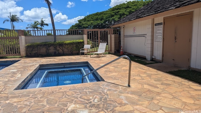 view of swimming pool featuring an in ground hot tub and a patio area