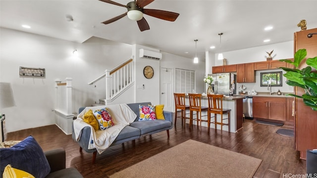 living room with ceiling fan, sink, a wall mounted air conditioner, and dark hardwood / wood-style floors