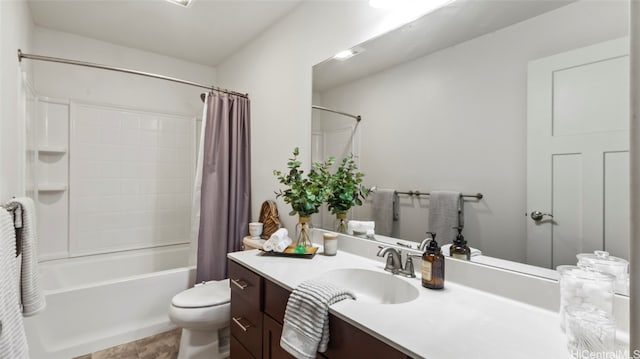 full bathroom featuring vanity, shower / bath combo with shower curtain, toilet, and tile patterned floors