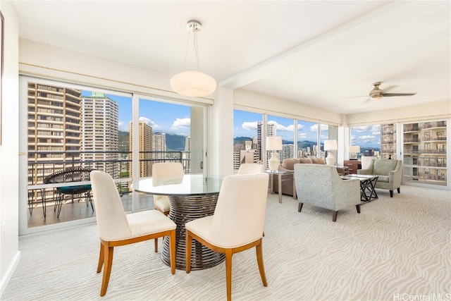 dining room featuring ceiling fan and light colored carpet