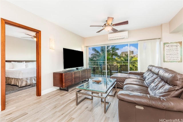 living room with an AC wall unit, light hardwood / wood-style floors, and ceiling fan