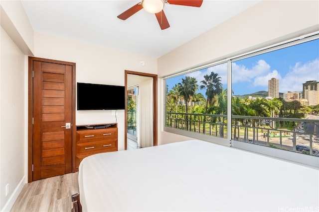 bedroom with light hardwood / wood-style flooring and ceiling fan