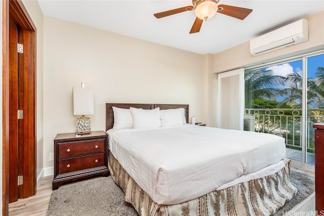 bedroom with a wall mounted AC, access to exterior, light wood-type flooring, and ceiling fan